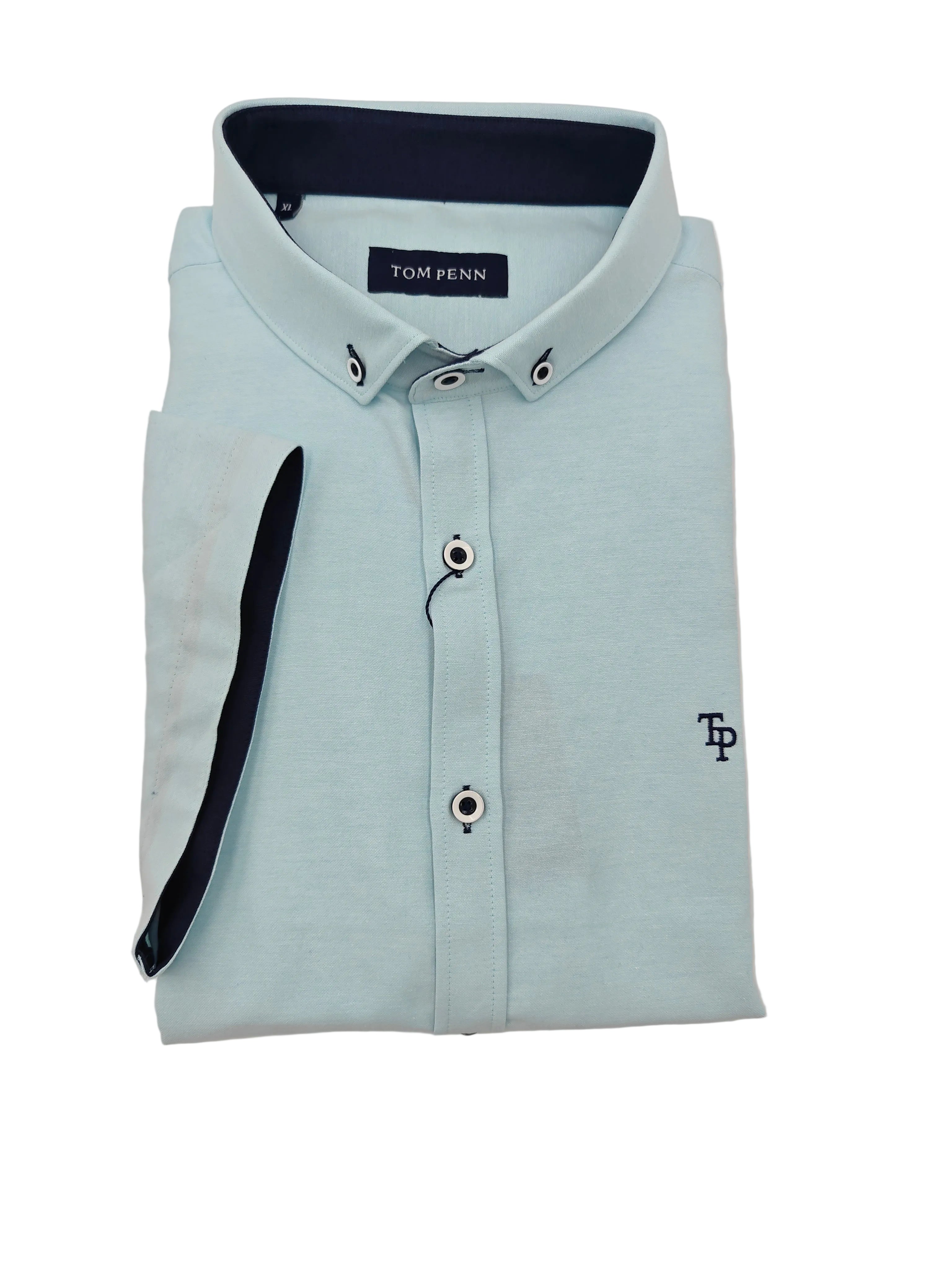 Folded light ocean blue short sleeve shirt with navy collar and trim on a white background
