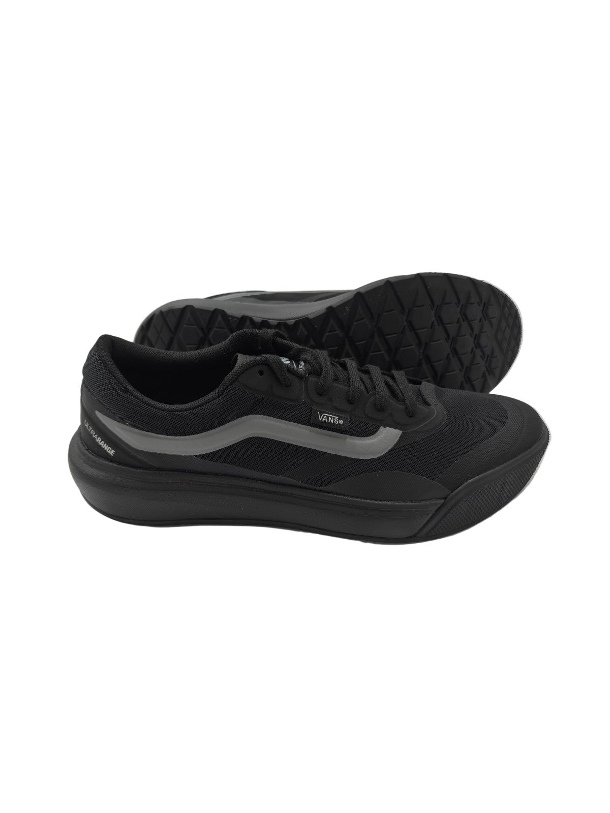 Black sneakers on a white surface with a reflective background