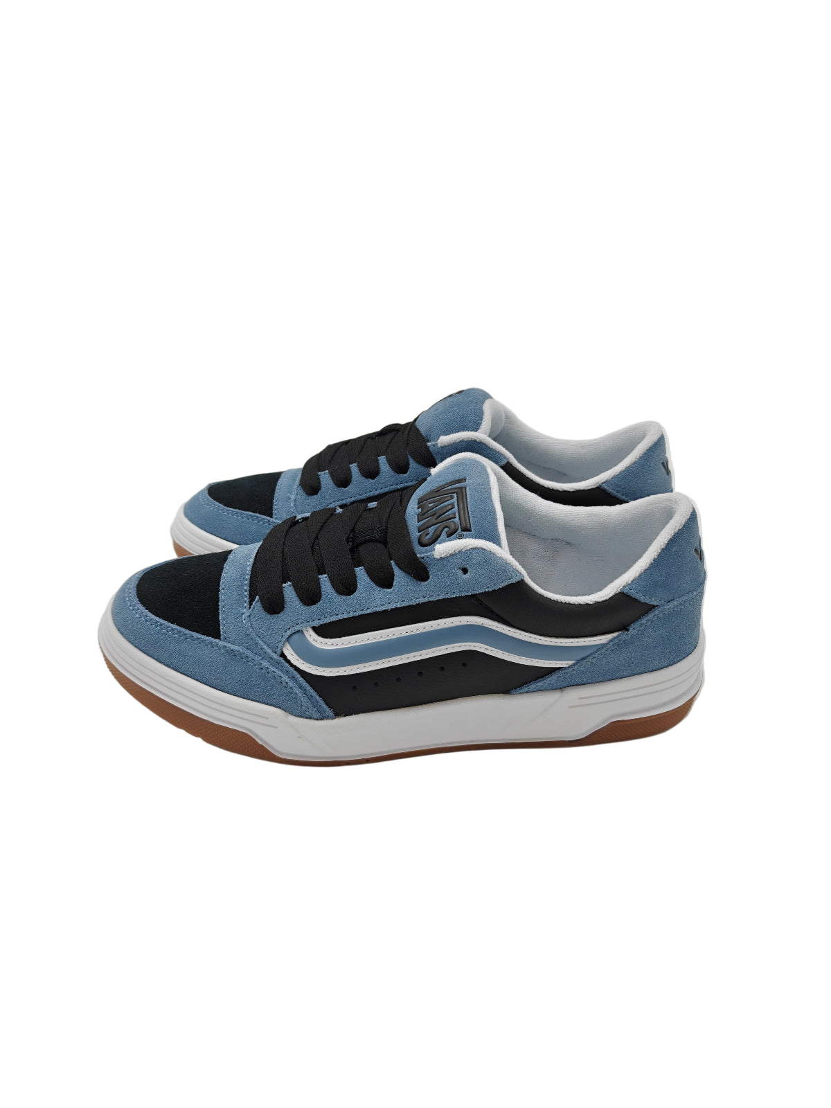 Blue and black sneakers with white soles on a clear stand.
