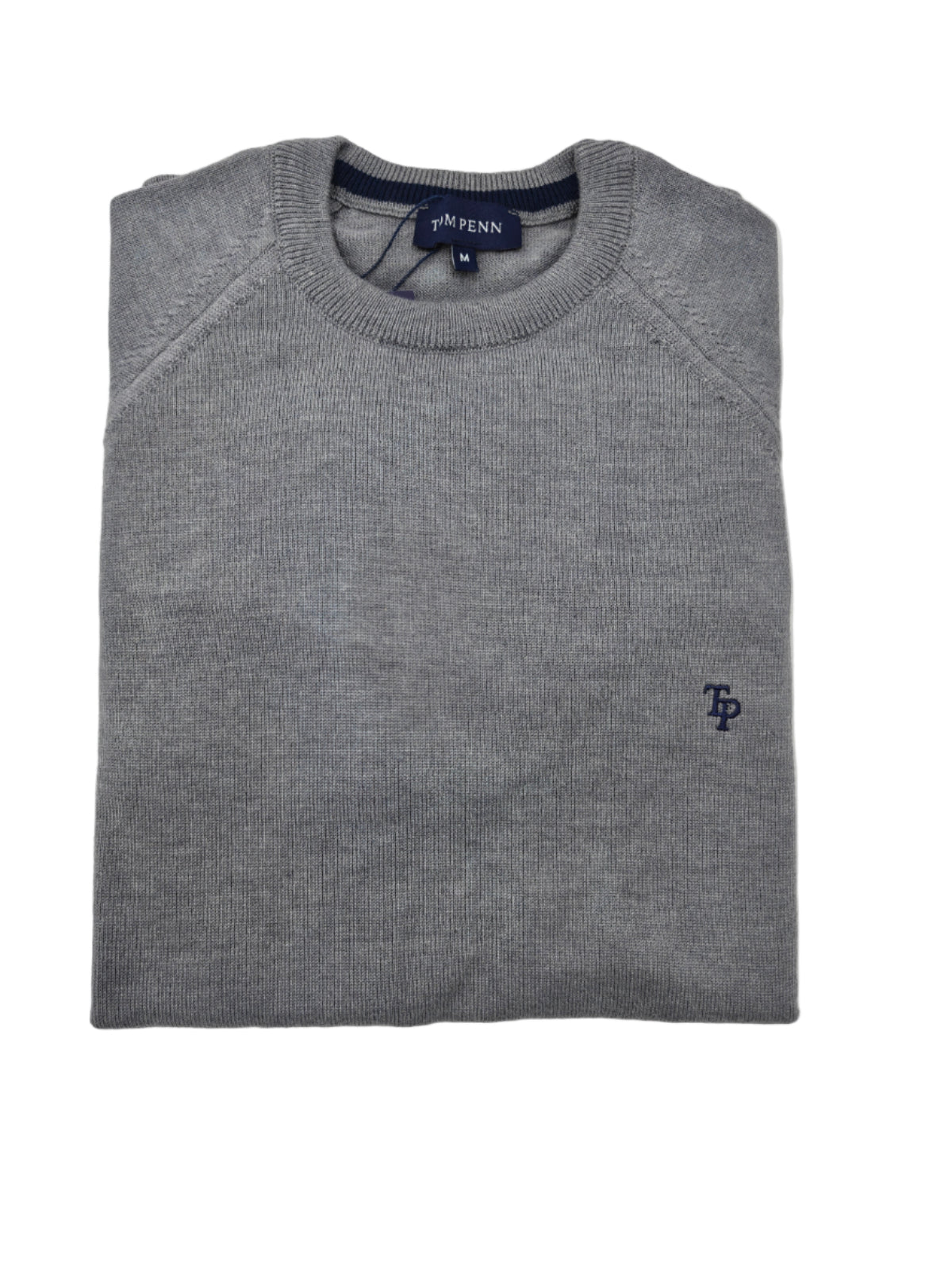 Folded gray sweater with a small logo on a light gray background