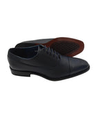 Side view of Goor men's navy Oxford dress shoe with textured upper and toe cap