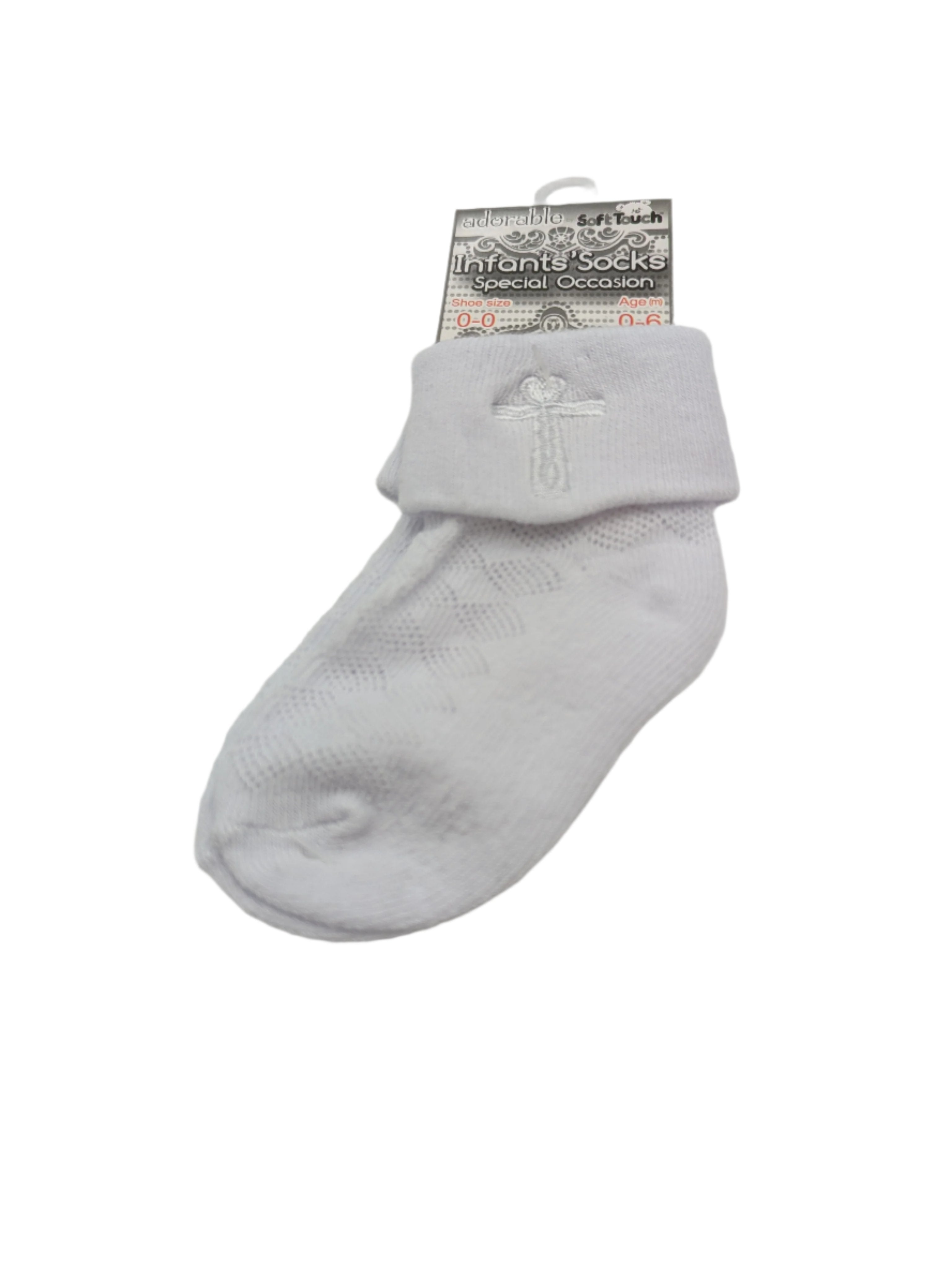 Close-up of baby white christening socks with white cross detail