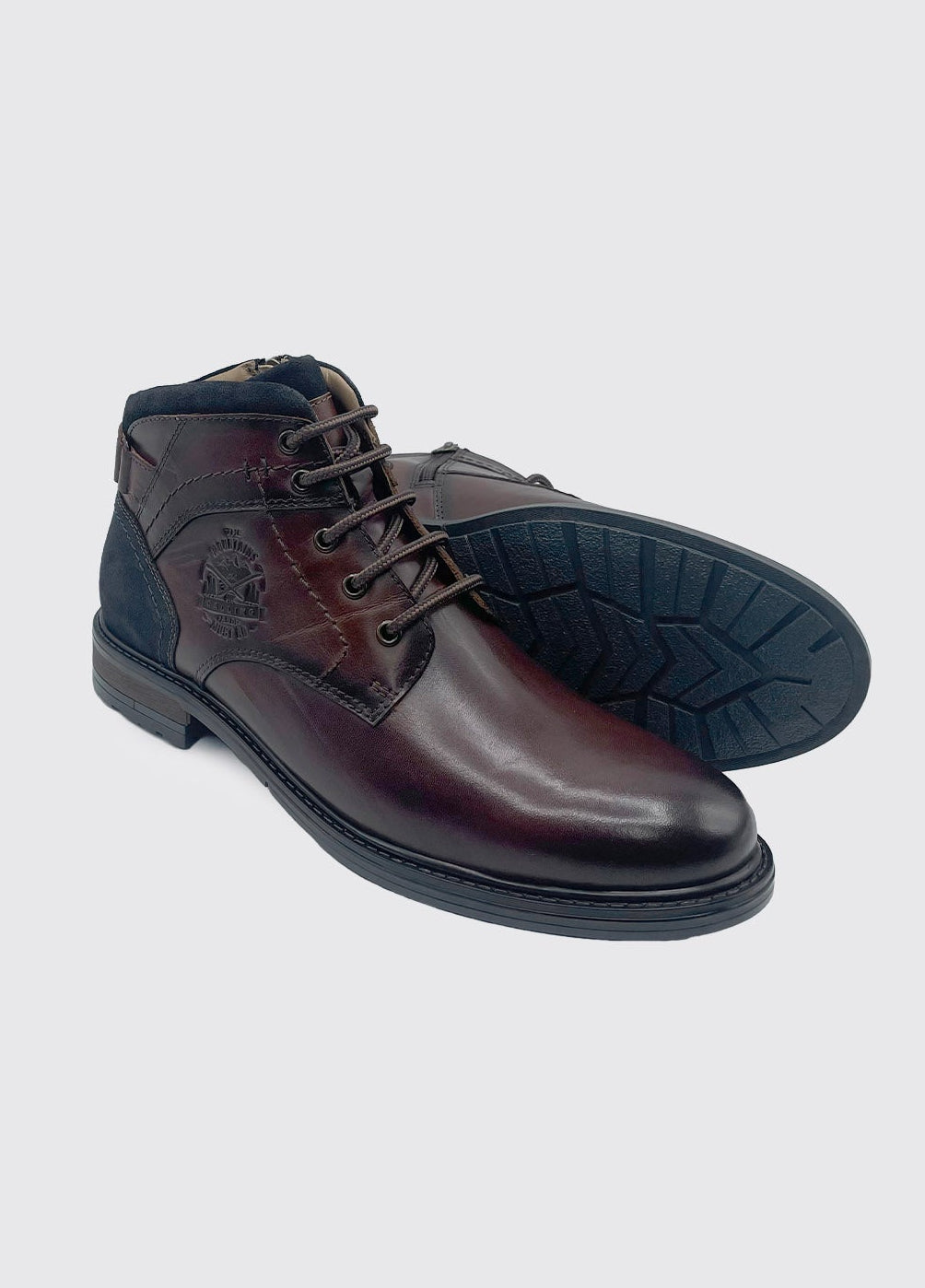 Pair of brown leather shoes on a light gray background
