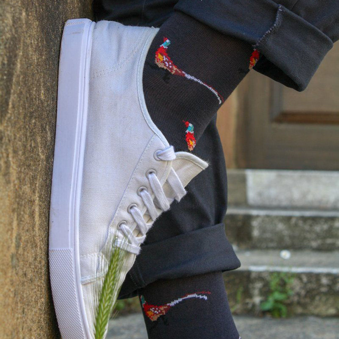 Man wearing pheasant design bamboo socks with a white sneaker