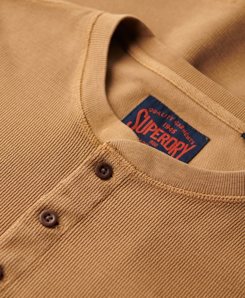 Close-up of a brown garment with a Superdry label