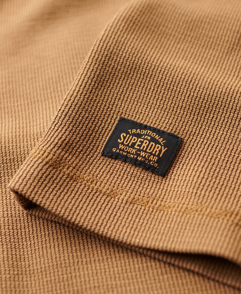 Close-up of a Superdry label on a brown textured fabric