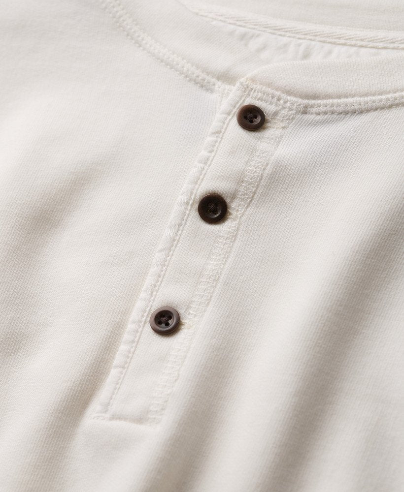 Close-up of a white shirt with buttons on a light background