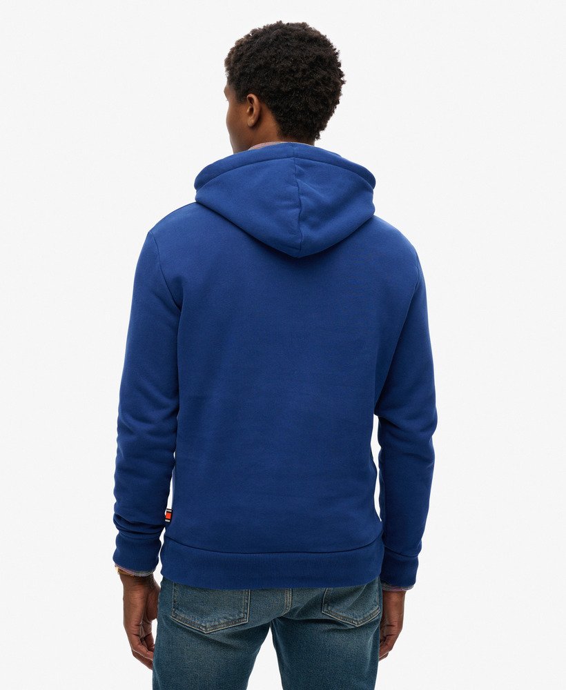 Man wearing a navy blue hoodie with a Superdry flyers script longo on the front-Back view