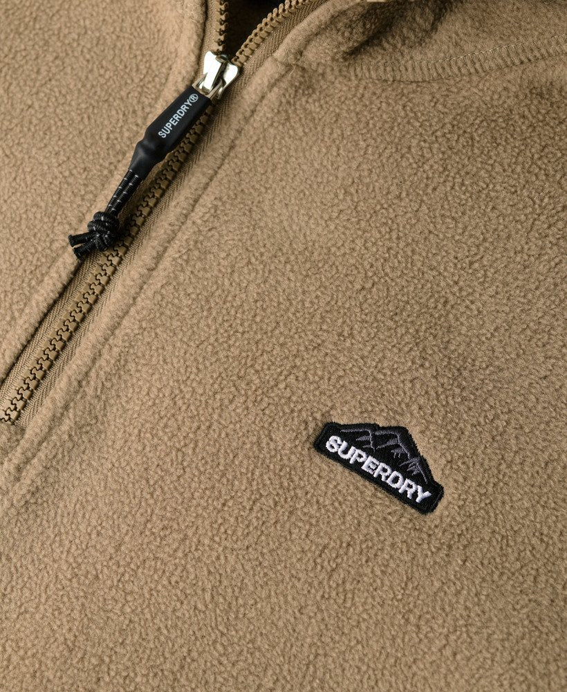 Close-up of a brown fleece jacket with Superdry logo and zipper detail