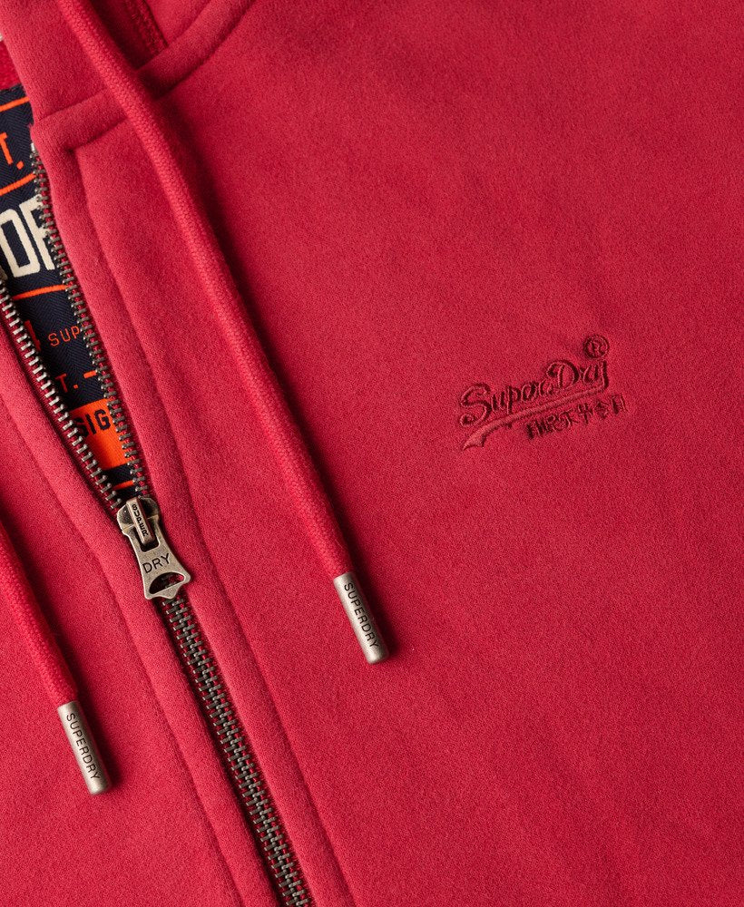 Close-up of a red hoodie with a brand logo on the chest.