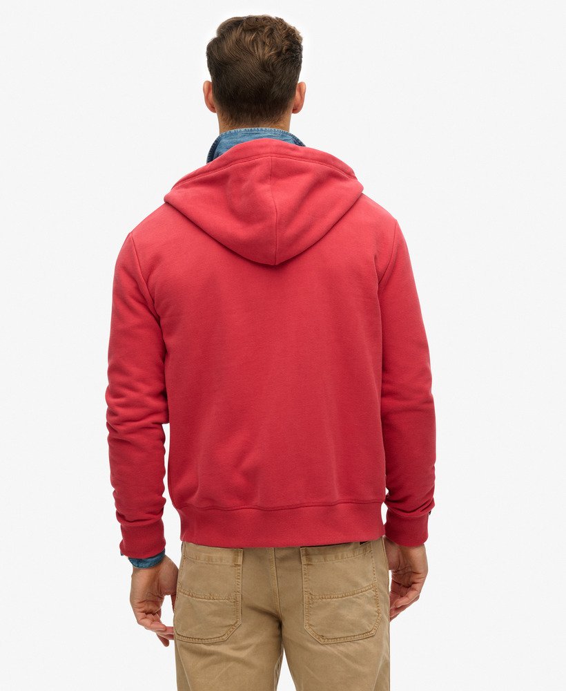 Person wearing a red hoodie from behind on a white background