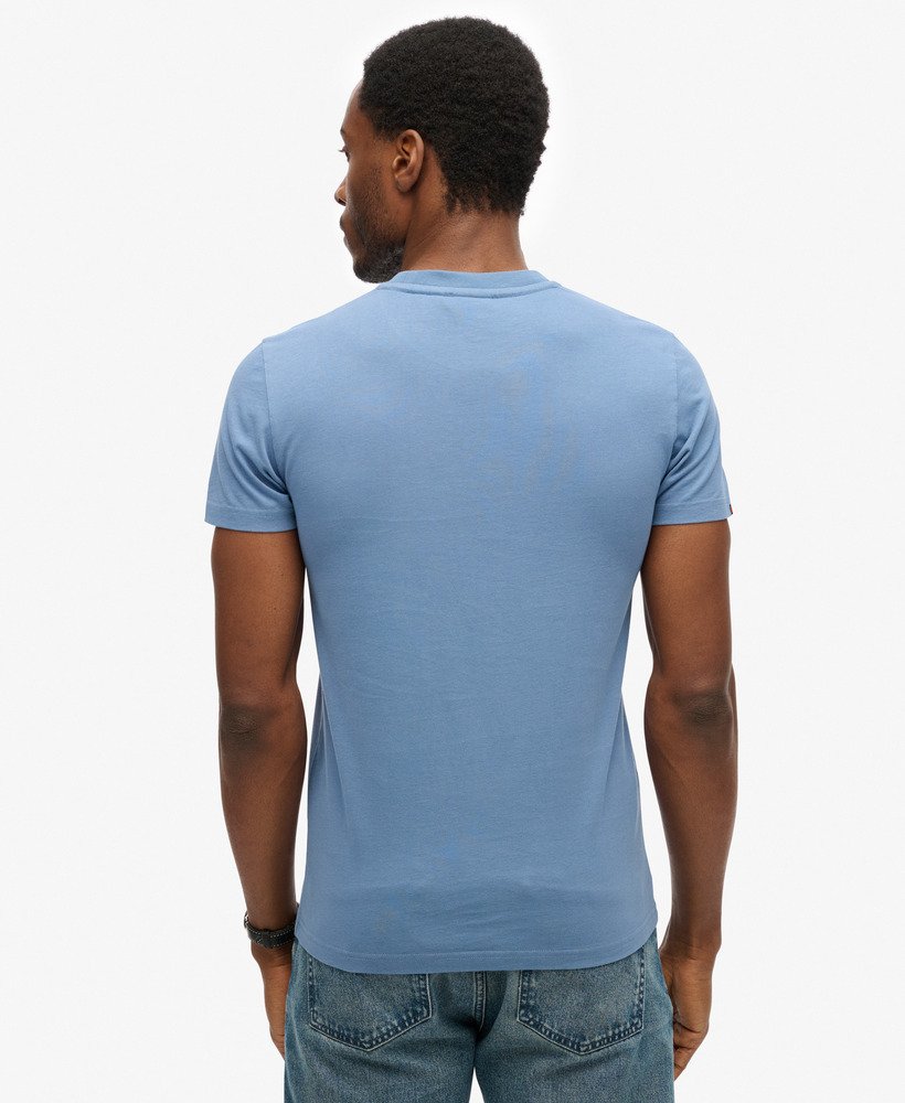 Man wearing a blue t-shirt on a white background- Back view