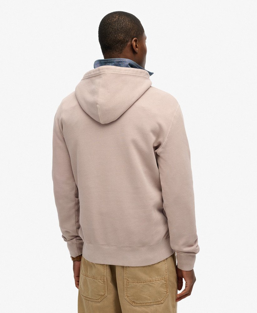 Person wearing a beige hoodie from behind on a white background