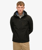 Man wearing a black jacket on a white background