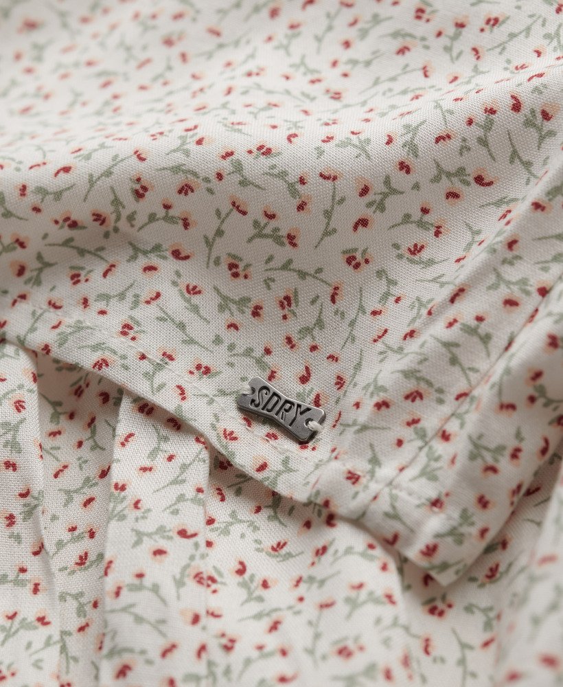 Floral patterned fabric with a visible brand label on a white background