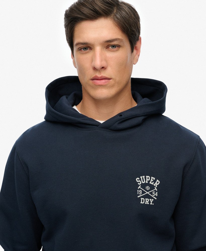 Man wearing a navy hoodie with 'Super Dry' logo on a white background