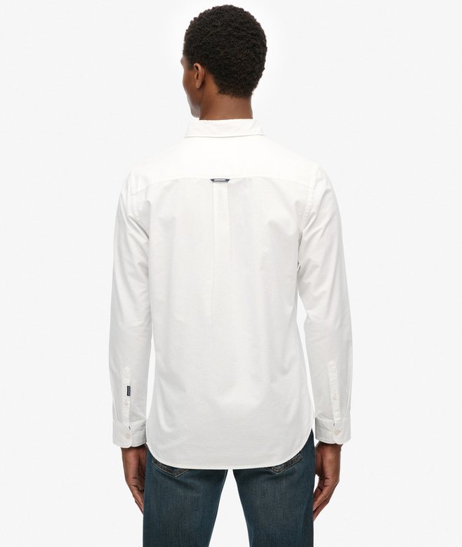 Person wearing a white long-sleeve shirt on a white background