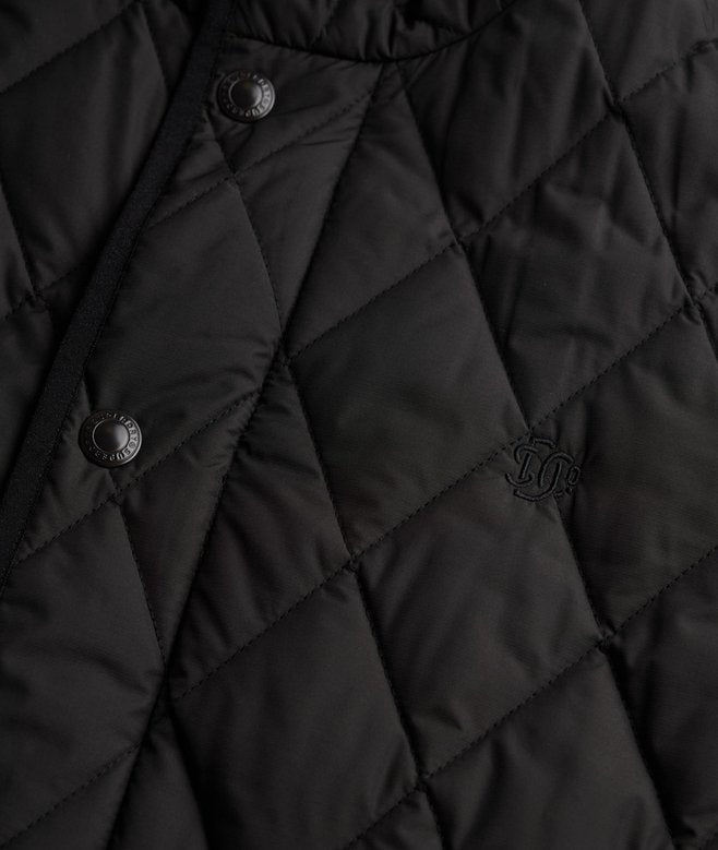 Close-up of a black quilted jacket with brand logo