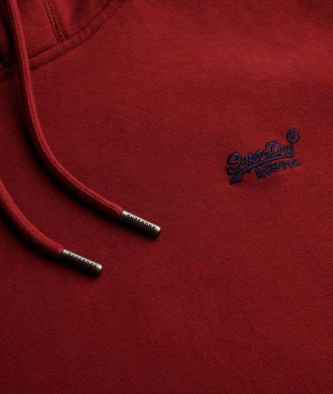 Red hoodie with a visible brand logo on a close-up of the chest area.