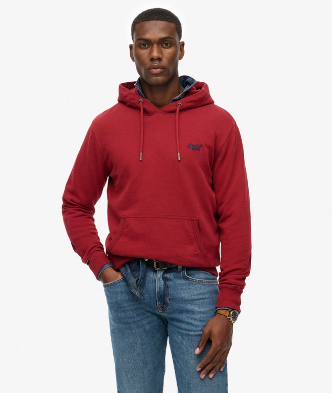 Man wearing a red hoodie and blue jeans on a white background
