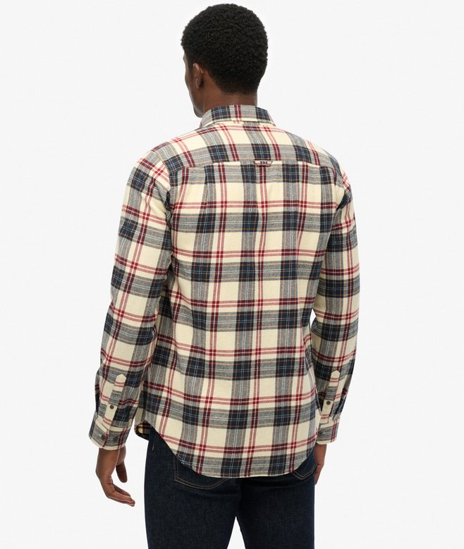Person wearing a plaid shirt on a white background