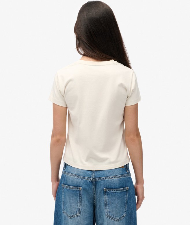Person wearing a white t-shirt and blue jeans on a plain background