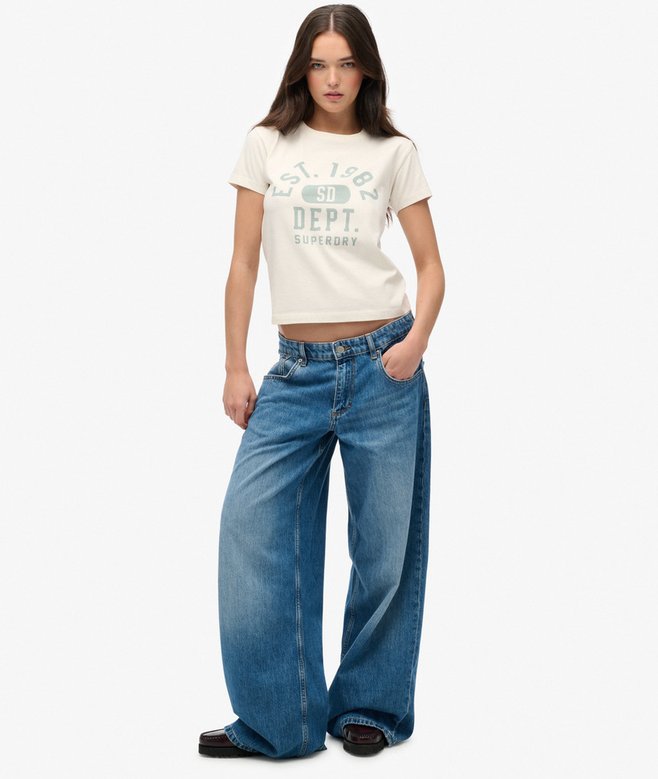 Woman wearing a white t-shirt with text and blue jeans on a white background