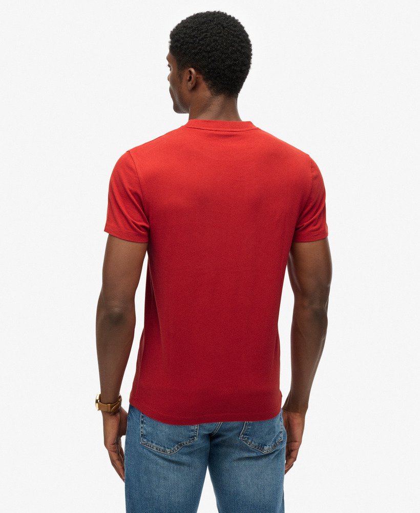 Person wearing a red t-shirt and blue jeans on a white background