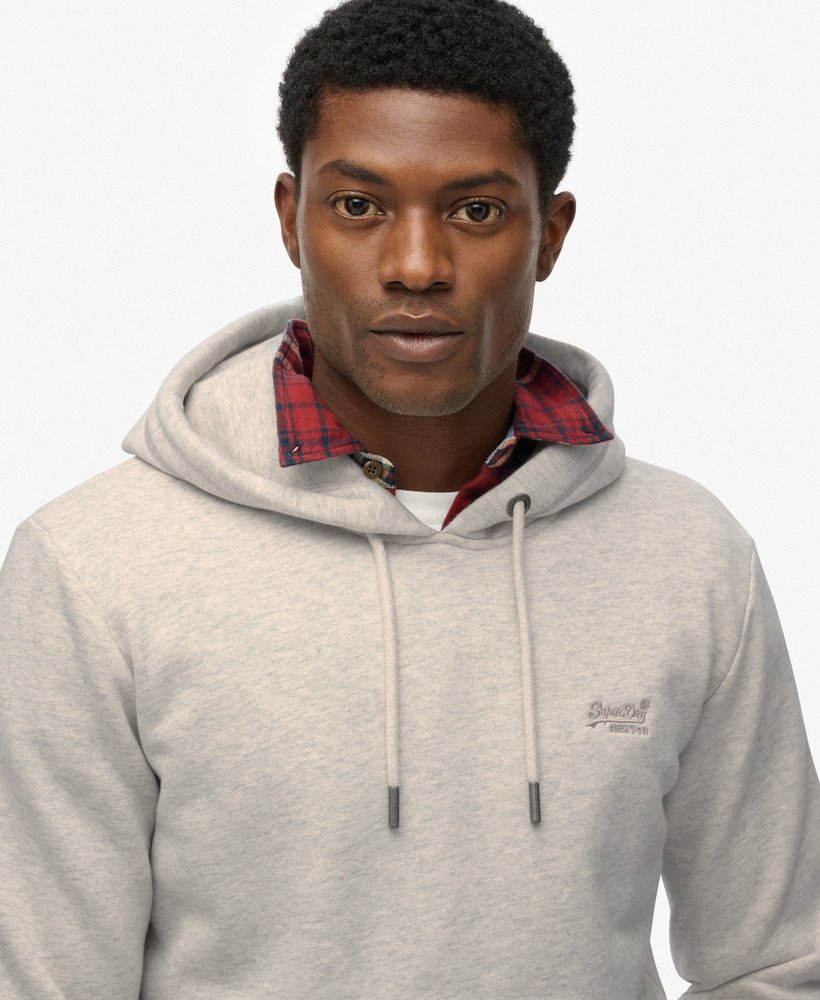 Man wearing a gray hoodie with a plaid collar on a white background
