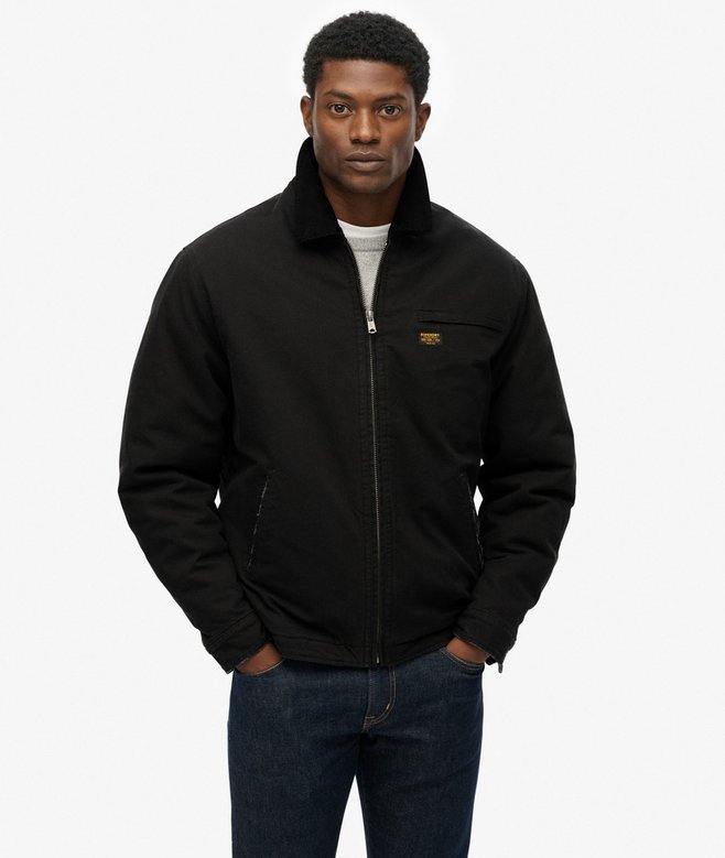 Man wearing a black jacket with a brand logo on a white background