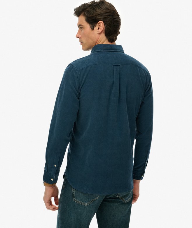 Man wearing a dark blue button-up shirt on a white background