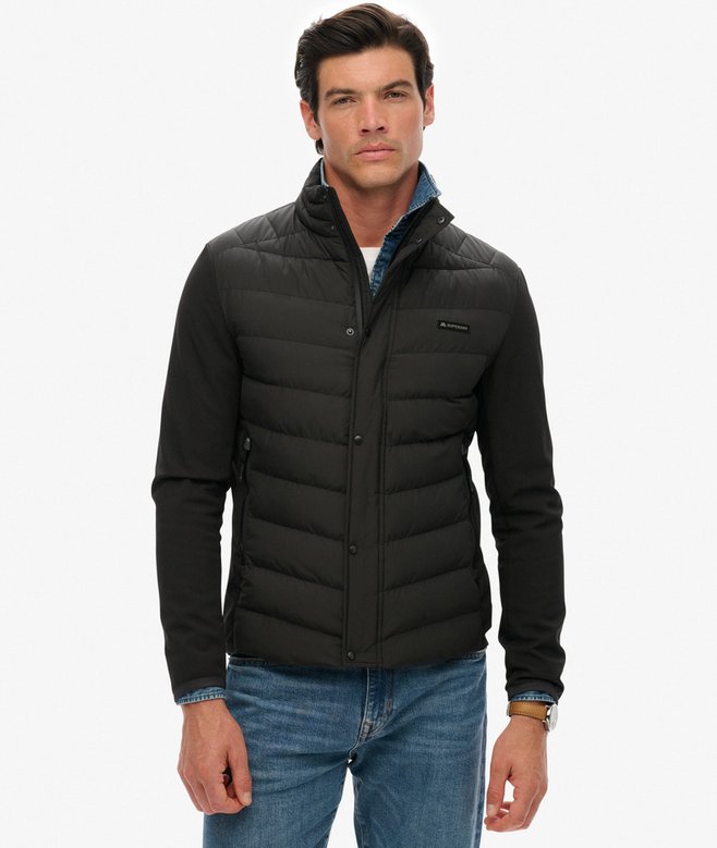Man wearing a black puffer jacket on a white background