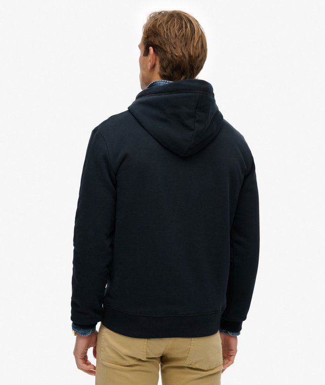 Man wearing a navy hoodie  from behind on a white background