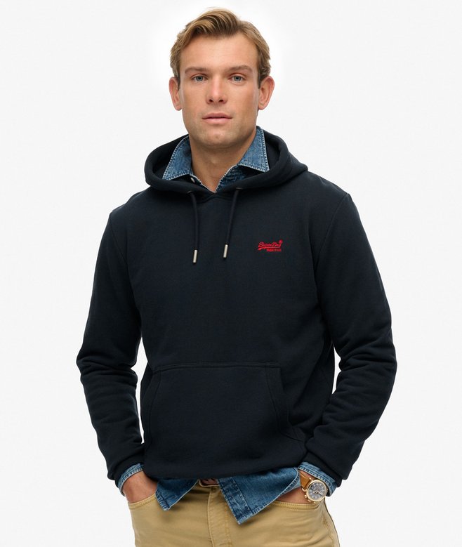 Man wearing a navy hoodie with a red logo on a white background