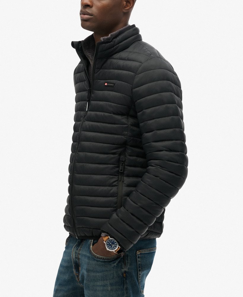 Man wearing a black puffer jacket on a white background