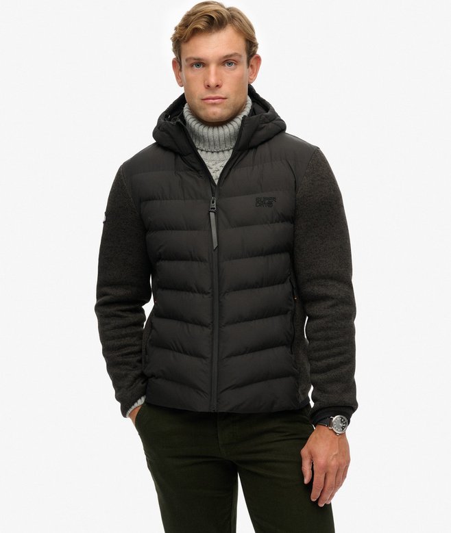 Man wearing a black puffer jacket on a white background