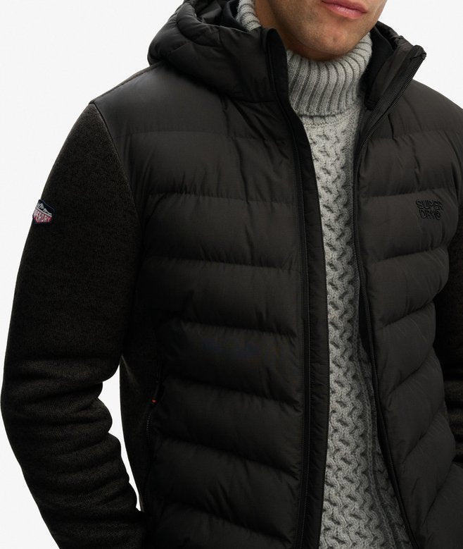 Black puffer jacket with brand logo on a white background