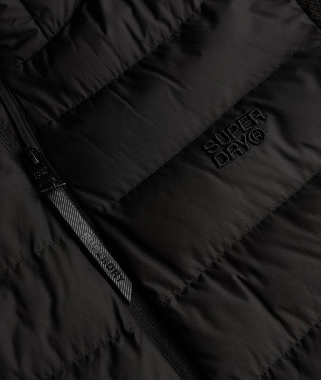 Close-up of a black puffer jacket with Superdry logo