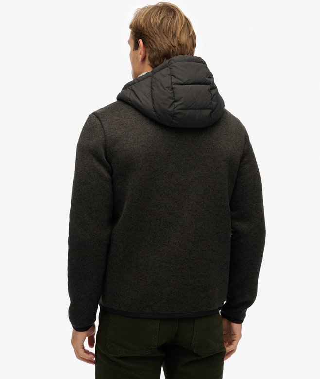 Man wearing a black hooded jacket on a white background