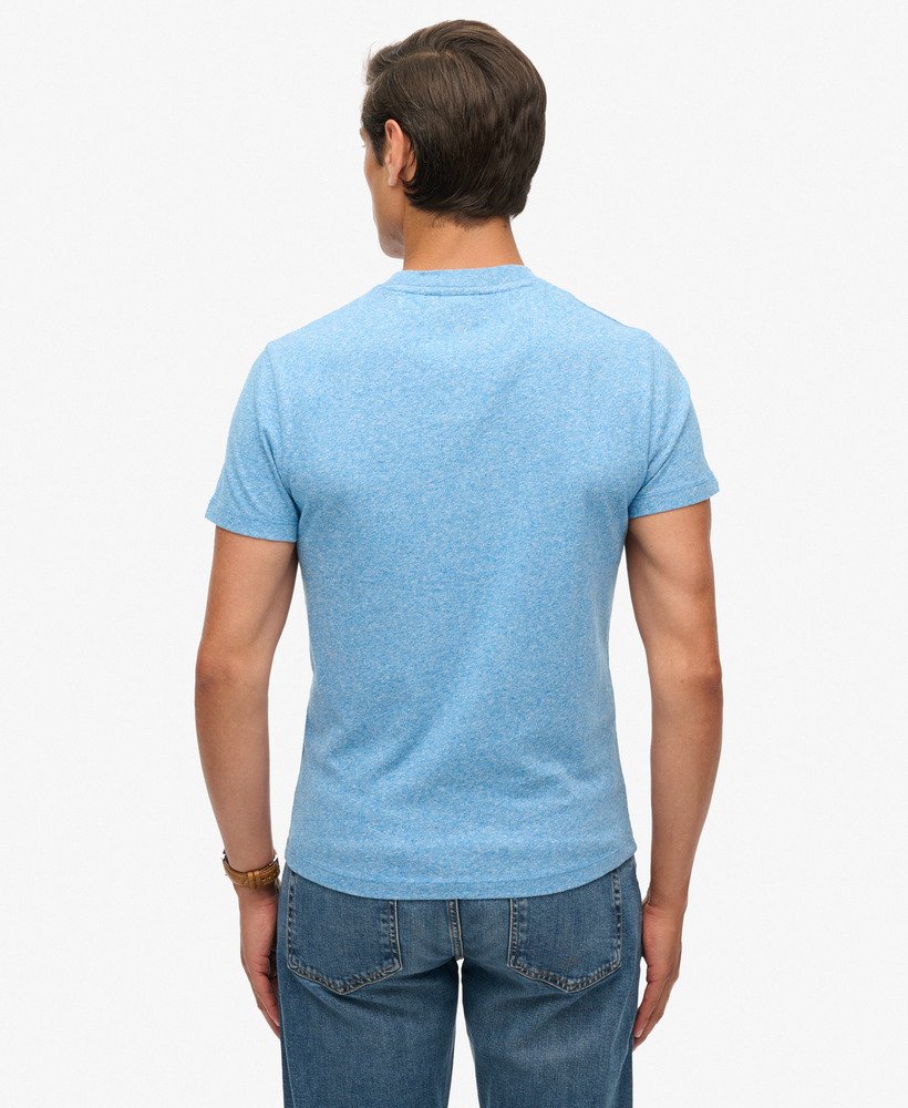 Person wearing a light blue t-shirt and jeans on a white background