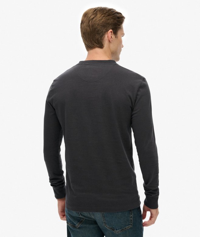 Man wearing a dark gray long-sleeve shirt on a white background