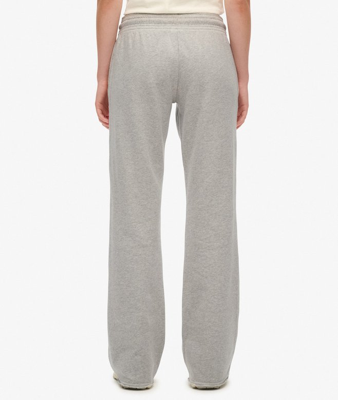 Gray sweatpants worn by a person on a white background