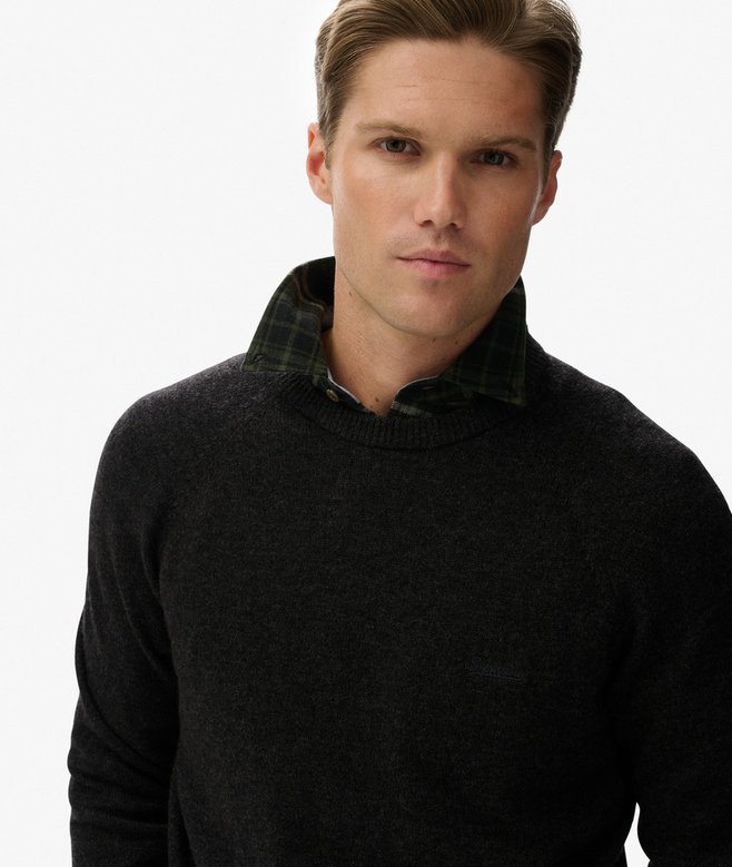 Man wearing a dark gray sweater on a white background