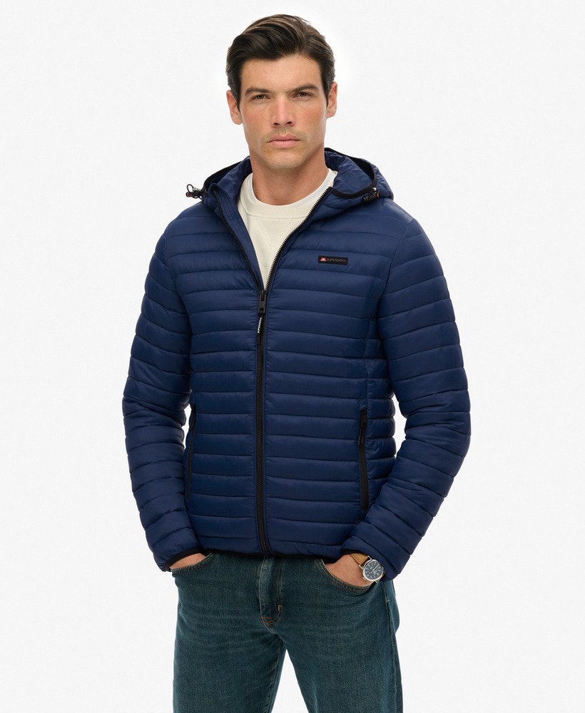 Man wearing a blue puffer jacket on a white background