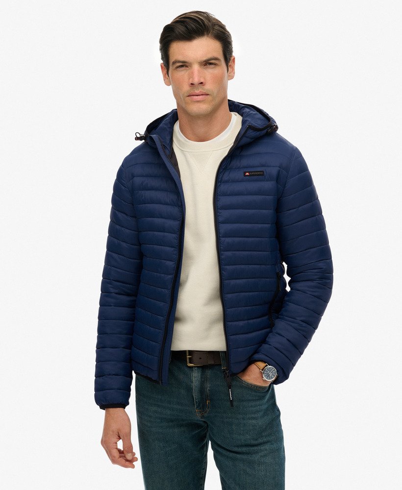 Man wearing a blue puffer jacket on a white background