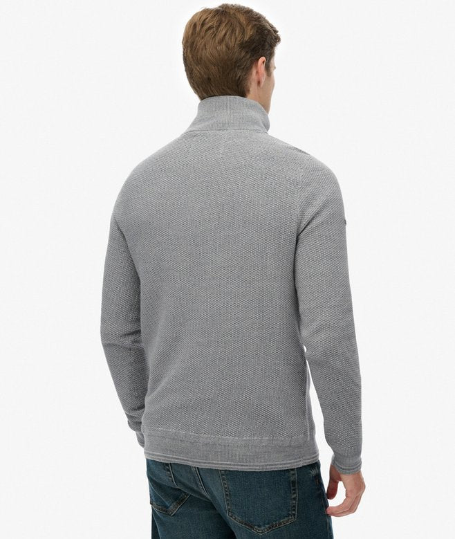 Man wearing a gray textured sweater on a white background