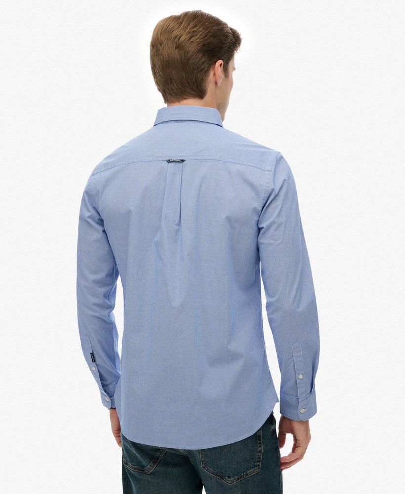 Man wearing a light blue shirt on a white background