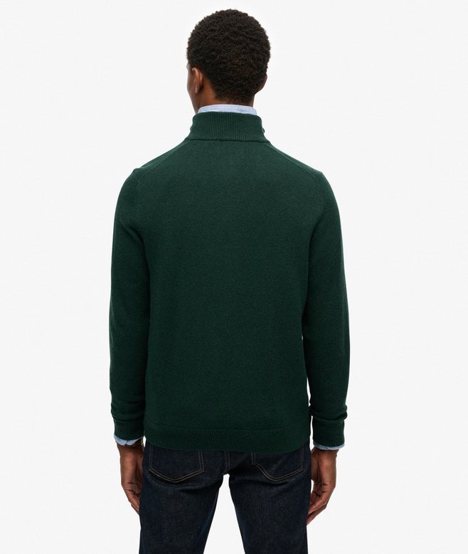 Person wearing a green sweater on a white background