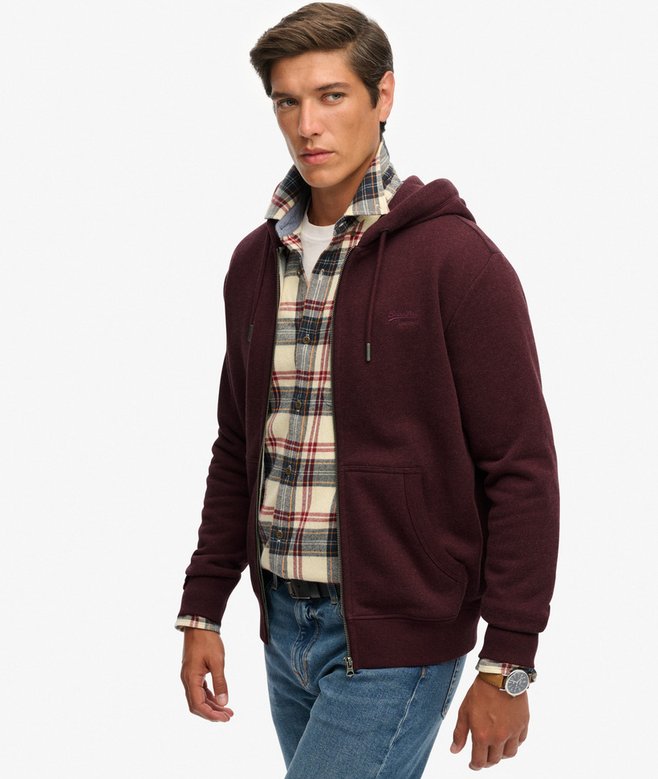 Man wearing a maroon hoodie with a plaid shirt underneath on a white background