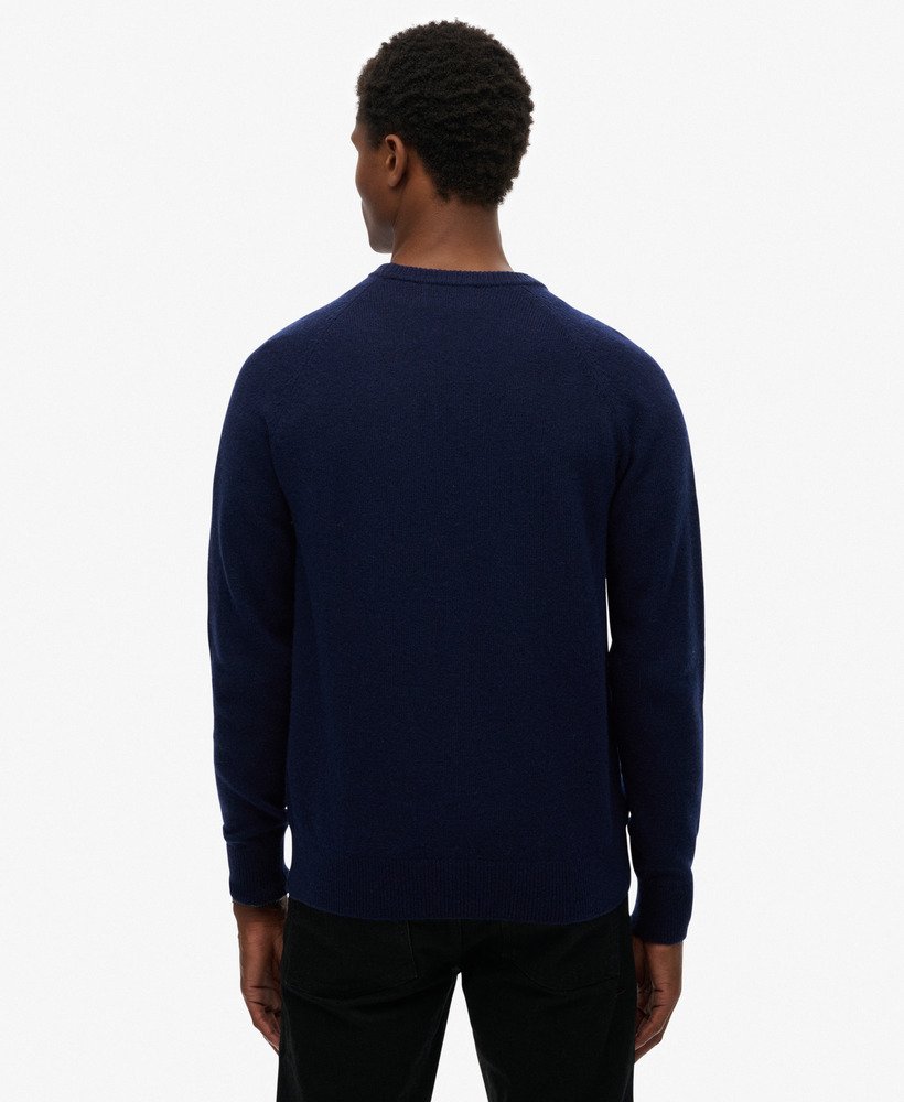 Man wearing a navy blue sweater on a white background